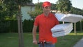 CLOSE UP: Courier delivering pizzas drops a cardboard box while riding e-scooter
