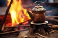 close-up of cowboy coffee pot on open campfire