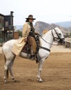 Close up of a Cowboy Riding his horse into town Royalty Free Stock Photo