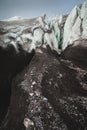 Close-up Crack is a deep blue crack found in the ice sheet and black mud on the glacier. Wide angle and dramatic sky Royalty Free Stock Photo