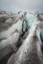 Close-up Crack is a deep blue crack found in the ice sheet and black mud on the glacier. Wide angle and dramatic sky Royalty Free Stock Photo