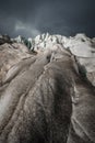 Close-up Crack is a deep blue crack found in the ice sheet and black mud on the glacier. Wide angle and dramatic sky Royalty Free Stock Photo