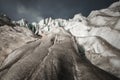 Close-up Crack is a deep blue crack found in the ice sheet and black mud on the glacier. Wide angle and dramatic sky Royalty Free Stock Photo