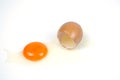 Cracked egg, eggshell with yolk isolated on white background Royalty Free Stock Photo