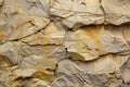 Close-up of a Rough, Cracked Stone Wall with a Layered Texture Royalty Free Stock Photo