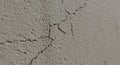 Close-up of a cracked wall surface, displaying a network of fine fissures and texture. Royalty Free Stock Photo