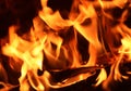 Close up on a crackling warm camp fire burning with red and orange flames Royalty Free Stock Photo