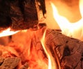 Close up on a crackling warm camp fire burning with red and orange flames Royalty Free Stock Photo