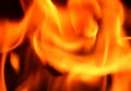 Close up on a crackling warm camp fire burning with red and orange flames Royalty Free Stock Photo