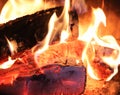 Close up on a crackling warm camp fire burning with red and orange flames Royalty Free Stock Photo