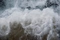 Close up of crashing wave as it foams off of breakwater. Royalty Free Stock Photo