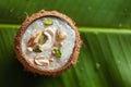 Close-up of Creamy Sabudana Kheer Garnished with dry fruits. Indian delicious dessert. Served in a coconut shell. on banana leafna Royalty Free Stock Photo