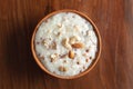 Close-up of Creamy Sabudana Kheer Garnished with dry fruits. Indian delicious dessert. Served in an earthen pot. On Wooden