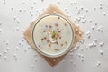 Close-up of Creamy Sabudana Kheer Garnished with dry fruits. Indian delicious dessert. Served in -white ceramic bowl.