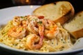 Close-up of Creamy Shrimp Scampi Pasta with Garlic Bread and Parmesan Cheese Royalty Free Stock Photo