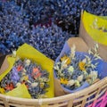 Close-up of creative bouquets of fresh lavender flowers in wicker basket, flower shop, studio. Delivery of flowers