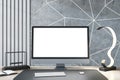 Close up of creative designer desk top with empty white computer monitor, various items and light concrete wall. Mock up, 3D Royalty Free Stock Photo