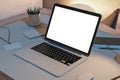 Close up of creative designer desktop with blank white laptop computer screen and supplies. Mock up, 3D Rendering. Workplace Royalty Free Stock Photo