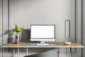 Close up of creative designer desktop with clean white computer screen, keyboard, decorative plant and other items on concrete Royalty Free Stock Photo