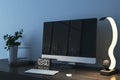 Close up of creative designer desktop with empty mock up computer monitor with city reflections, supplies and various items on Royalty Free Stock Photo