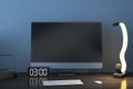 Close up of creative designer desktop with empty mock up computer monitor, supplies and various items on blue concrete wall Royalty Free Stock Photo