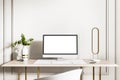 Close up of creative designer desktop with empty white computer screen, keyboard, decorative plant and other items on concrete Royalty Free Stock Photo