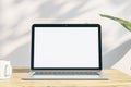 Close up of creative designer office desktop with empty white laptop display with mock up place in frame, concrete wall background Royalty Free Stock Photo