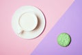 Close up Creative flat lay of green pistachio cake and white cup of milk on trendy pastel pink and violet background. Abstract bac