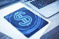 Close up of creative glowing dollar sign and tablet on office desktop background with hologram. Currency and online banking