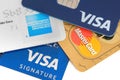Close up of credit cards with MasterCard,Visa and American Express logos on white background,illustrative