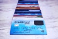 Close up of credit cards stack on wooden surface. Bunch of payment cards with biometric card lying on the top. Concept of paying Royalty Free Stock Photo