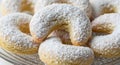Close up of crescent cookies dusted with powdered sugar on a plate Royalty Free Stock Photo