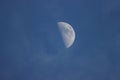 Close up of the crescent moon in the daytime with blue sky Royalty Free Stock Photo