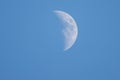 Close up of the crescent moon in the daytime with blue sky Royalty Free Stock Photo