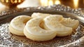 Close up of crescent moon shaped cookies with white icing on an ornate silver platter Royalty Free Stock Photo