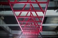 Close-up of pink horizontal bars for a workout, cylindrical crimson metal bars on a light silvery background.