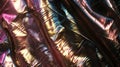 Close-up of crinkled pleather with a vivid holographic sheen, creating a dazzling array of colors and textures