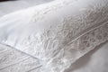 close-up of crisp, clean pillowcase with intricate stitching