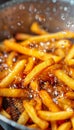 Close up of crispy french fries being cooked in a deep fryer for a delicious snack