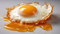 Close-up of a crispy fried egg with a runny yolk on a white surface