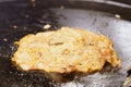 Close-up of Crispy Fried Mussel Pancake or Mussel Omellette on hot pan, thai street food market Royalty Free Stock Photo