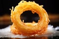 a close-up of a crispy onion ring showcasing texture