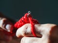 Close-up crocheting with red wool yarn on a dark background Royalty Free Stock Photo