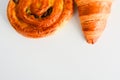 Close up on croissants, Danish pastry and chocolate and raisin filled pastries