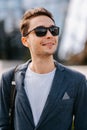 Close up crop portrait of a handsome young man wearing sunglasses outdoors. Royalty Free Stock Photo