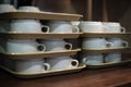 Close up, crop. White coffee cups stacked in rows in a restaurant Royalty Free Stock Photo