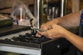 Close-up crop of woman making change at old cash register with American money in her hand with blurred bokeh background of inside