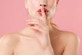 Close up cropped blonde half naked woman 20s perfect skin lips nude make up isolated on pastel pink wall background Royalty Free Stock Photo