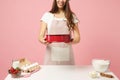 Close up cropped chef cook confectioner or baker in apron white t-shirt cooking cake or cupcake at table hold baking Royalty Free Stock Photo