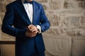 A close-up of a cropped frame of a man in an expensive classic costume looks at his watch. The businessman is in a hurry Royalty Free Stock Photo